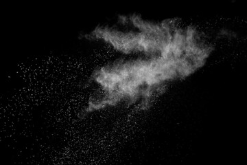Fototapeta na wymiar Freeze motion of white color powder exploding on dark background.
