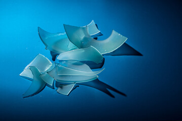 Shards of broken colored glass on a colored gradient background.