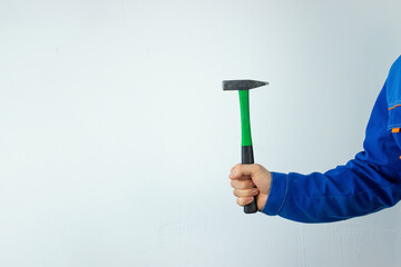 A man's hand with a construction tool on a white background.