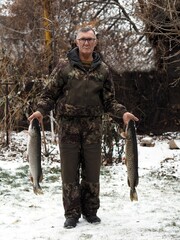 Naklejka premium Russian rivers. Just caught river large fish carp in the hands of a fisherman.