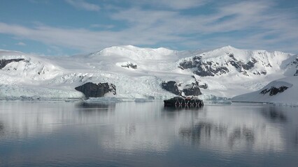 Environmental protection. Reflection of mountains and icebergs in the water. Antarctica. Fantastic wonderful amazing video. Life of nature, seaside and mountains.