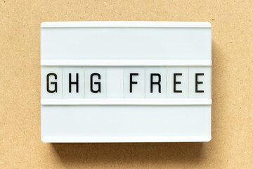 Lightbox with word GHG (Abbreviation of greenhouse gas) free on wood background