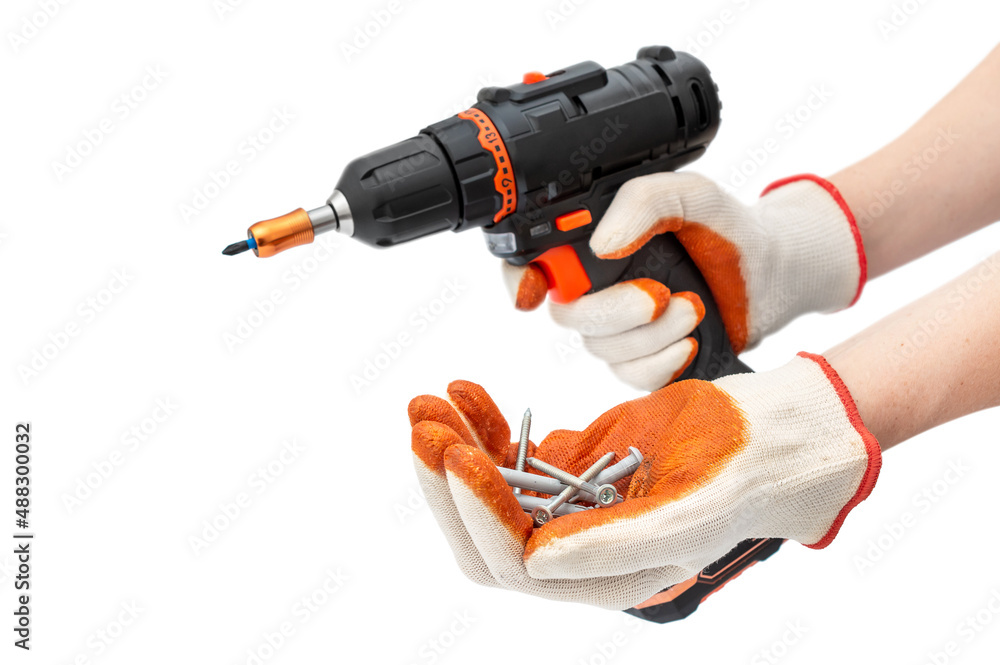 Sticker worker holding screws with dowels and accumulator screwdriver. isolated on white.