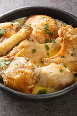 shkmeruli chkmeruli georgian cuisine chicken in a milk garlic sauce closeup in the plate on the table. Vertical