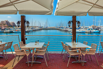 Fototapeta premium Outdoor restaurant and marina on background in Ashqelon, Israel.