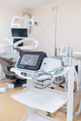 Modern dental clinic, dental chair and other accessories used by dentists in medical light.