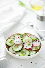 vegetable salad of cucumbers and radishes with olive oil and sesame seeds
