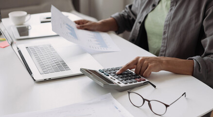 Woman accountant using calculator and computer in office panoramic banner, finance and accounting...