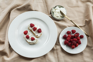 aesthetic breakfast, bruschetta with cream cheese and raspberries