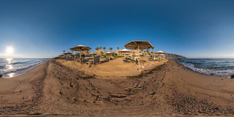 full seamless spherical hdr 360 panorama view on coast of sea with wooden beach umbrellas and sun loungers by red sea in bright sunny day in equirectangular projection, ready for VR AR virtual reality
