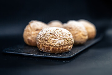 Appetizing Shu cakes on a black background.