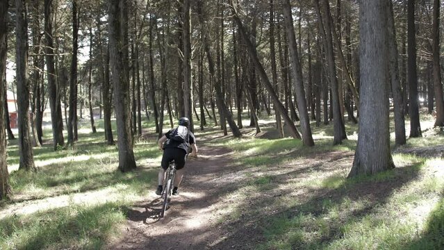 young man rides downhill mountain bike in forest slow motion 4k