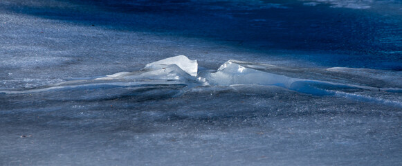 Texture of winter ice surface. Blue natural ice background. Farnebofjarden national park in north of sweden.