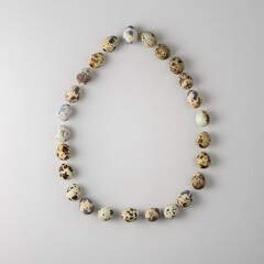 Creative Easter egg-shaped layout on gray background. Top view.