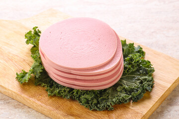 Slices pork sausage over board © Andrei Starostin