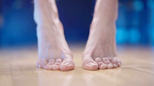 Person feet stand on toes with hallux valgus