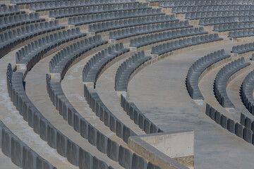 Modern outdoor amphitheater with rows of gray chairs