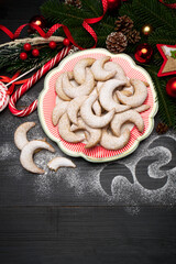 Traditional German or Austrian Vanillekipferl vanilla kipferl cookies on decorated ceramic plate