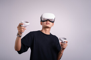 Surprised teen male student use vr glasses and looks at empty copy space .Virtual gadgets for entertainment, work, free time and study. Virtual reality metaverse technology concept.