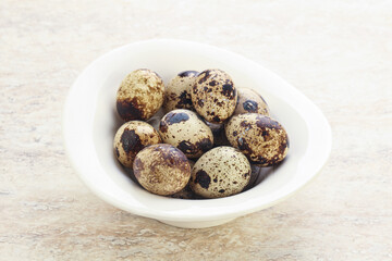 Raw quail eggs heap in the bowl