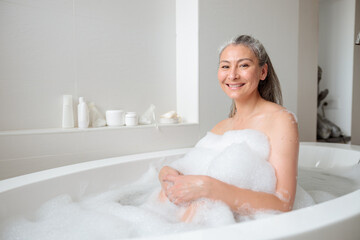 Positive adult woman resting after work in spa