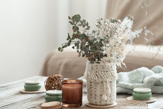 Cozy home background with dried flowers in a vase in the interior.