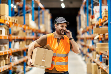 A delivery service worker using voice picking headset while holding shipment.
