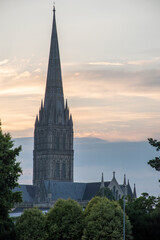 Fototapeta premium Salisbury Cathedral spire silhouetted against dusk/sunset skies. July 2021. Wiltshire, UK