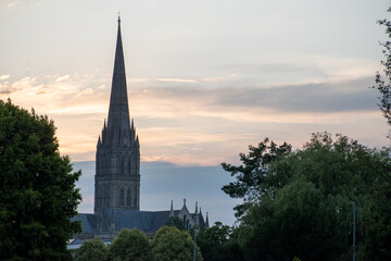 Fototapeta premium Salisbury Cathedral spire silhouetted against dusk/sunset skies. July 2021. Wiltshire, UK