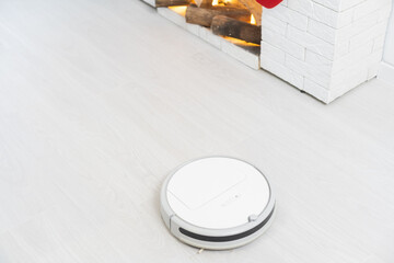 Obraz na płótnie Canvas Automated vacuum cleaning robot powered by rechargeable battery in modern living room