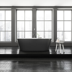 Fototapeta na wymiar Grey bathroom interior with bathtub and table with towel, panoramic window