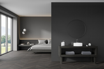 Dark bedroom interior with bed, panoramic window with countryside view