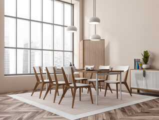 Light dining interior with seats, drawer and table near panoramic window