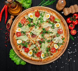 Pizza Caesar on board on wooden table