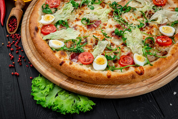 Pizza Caesar on board on wooden table