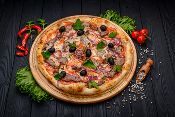 Delicious Italian pizza with meat, ham and vegetables