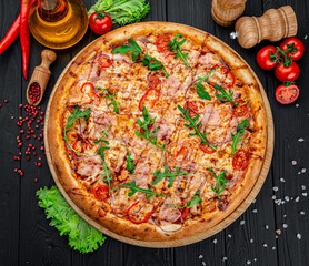 Delicious Italian pizza with sausage, ham and vegetables