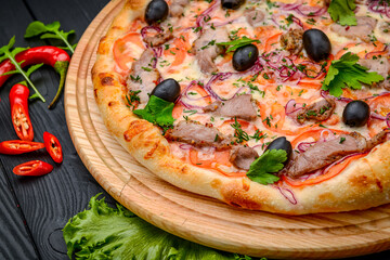 Delicious Italian pizza with meat, ham and vegetables