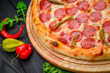 Delicious Italian pizza with sausage, ham and vegetables