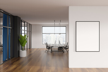 Modern office room interior, desktop computers on table, beige walls. Hardwood floor. Panoramic city view windows. White empty framed poster template. Concept of international coworking. 3d rendering