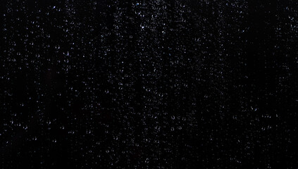 Water droplets on the black glass.