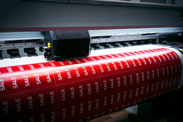Printing a poster with the inscription sale on a printed printer. The beginning of sales in stores....