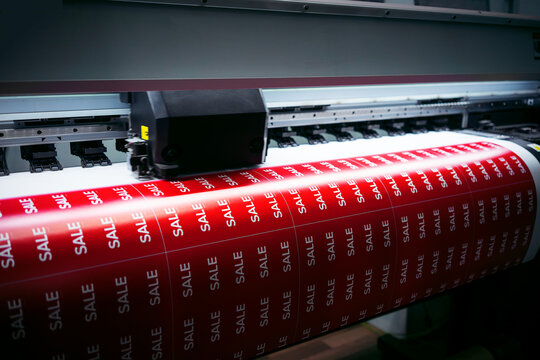 Printing a poster with the inscription sale on a printed printer. The beginning of sales in stores. Black Friday.