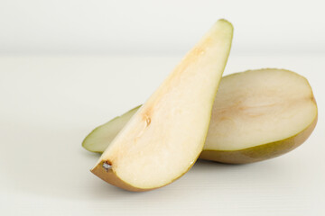 sweet juicy pear slices on white table