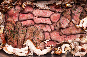 Baked and sliced pork, beef and lamb meat, top view. Meat background. © Сергей Жмурчак