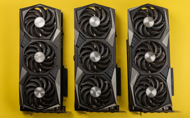 Game video card, video card adapter on a yellow background for video games and cryptocurrency mining. Computer parts. GPU card.
