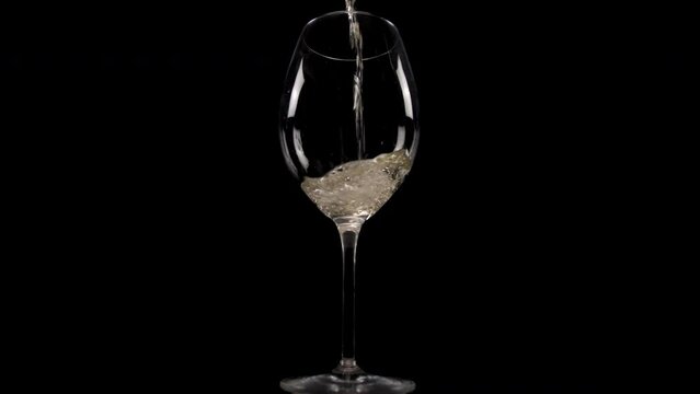 pouring white wine into glass slow motion 4k