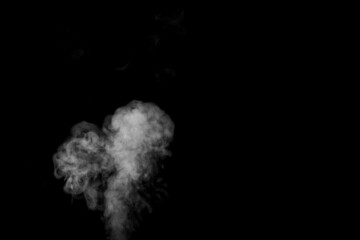 Swirling, wriggling smoke, heart-shaped steam, isolated on a black background for overlaying on...