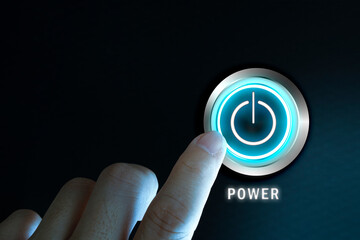 Finger about to press power button on a computer.