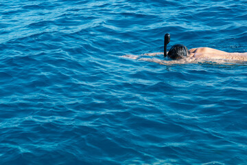 snorkeling man in full face mask, summer vacation activity